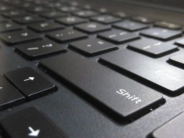 Close up of a Black keyboard, focus is primarily on the shift key
