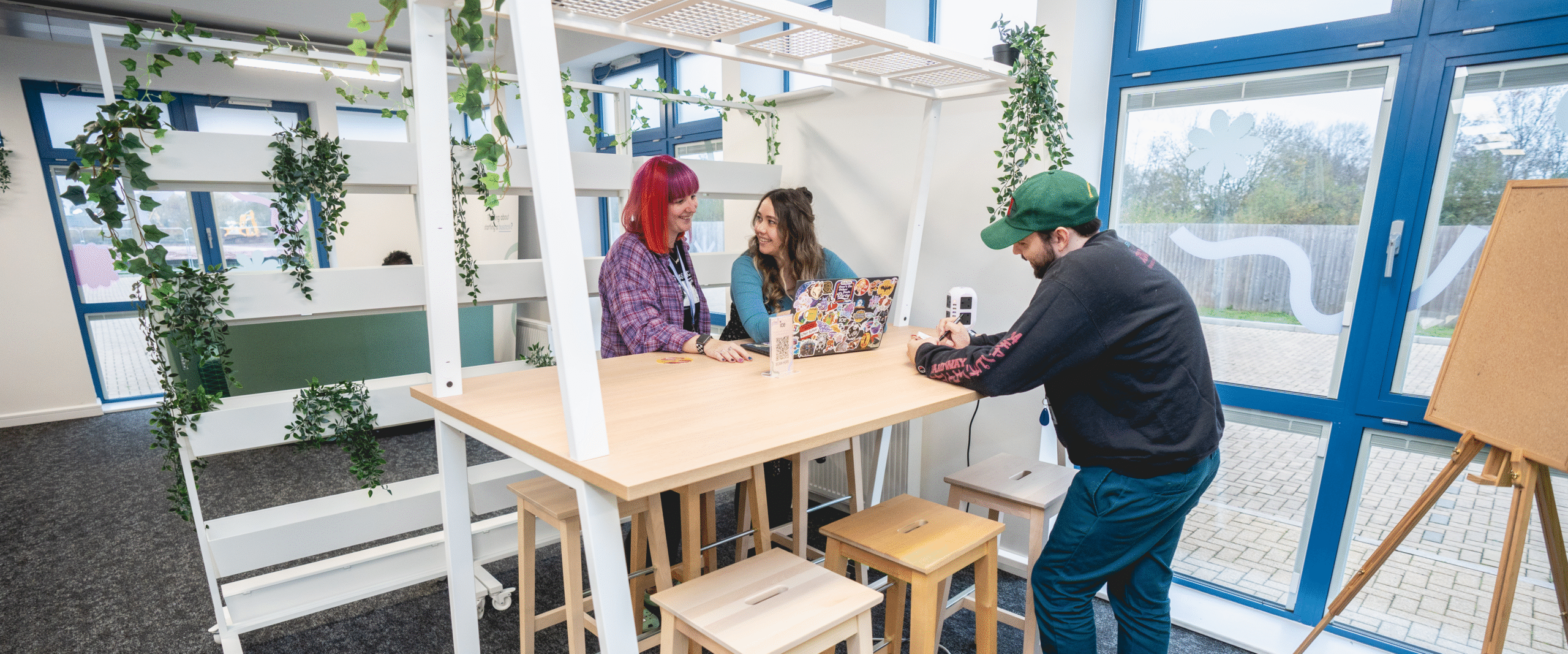 Coworkers chatting together while standing at desks.